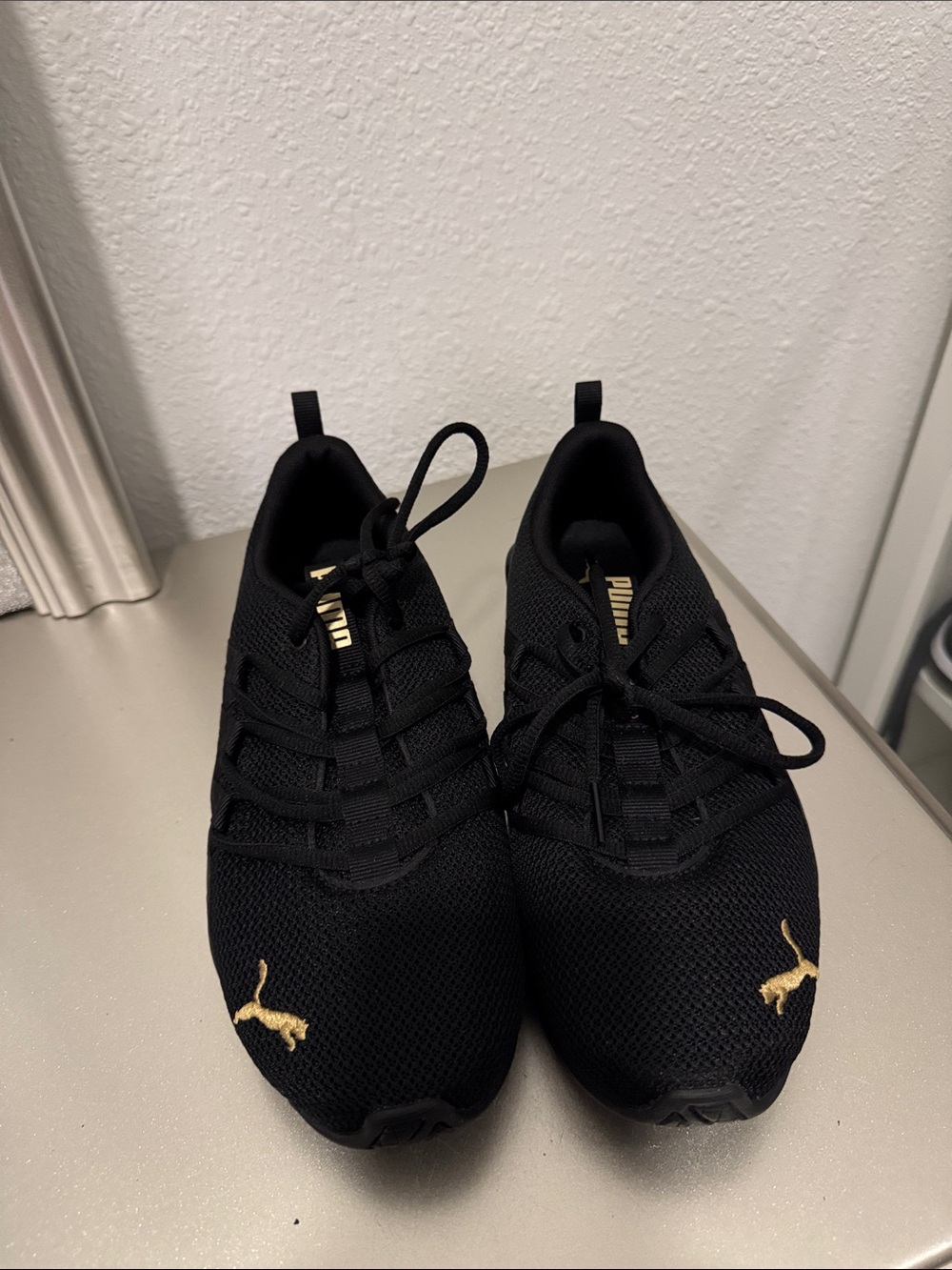 Puma Black Sneakers with Gold Accents
